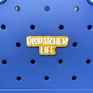 May include: A blue tote bag with a yellow sticker that says "Dispatcher Life".