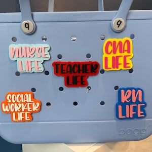 May include: A light blue tote bag with various colorful patches that say "Nurse Life", "Teacher Life", "CHA Life", "Social Worker Life", and "RN Life".