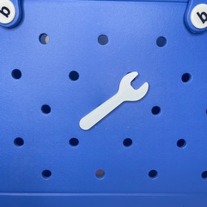 May include: A blue tote bag with a white wrench charm. The bag has a white "bo" logo on the bottom.