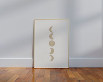 May include: A framed print with a minimalist design featuring a series of beige crescent moons in different phases, arranged vertically on a white background.