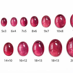 May include: A collection of oval-shaped, polished gemstones in varying sizes, ranging from 4x3 mm to 20x15 mm. The gems are a deep, rich red color, with a glossy surface. The sizes are labeled below each stone.