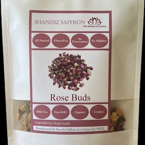 May include: A clear, resealable bag containing dried rose buds. The bag features a label with the text "SHANDIZ SAFFRON" and "Rose Buds." The label also includes the phrases "All Natural," "Gluten-Free," and "Organics."