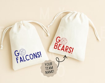 May include: Two white drawstring bags with team-themed text and volleyball graphics. One bag has blue text that reads "GO FALCONS!" and the other has red text that reads "GO BEARS!". A team name tag is also included.