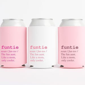 May include: Three beverage can coolers, two in light pink and one in white. Each cooler has the word "funtie" printed in pink, along with a definition: "The fun aunt. Like a mom, only cooler."