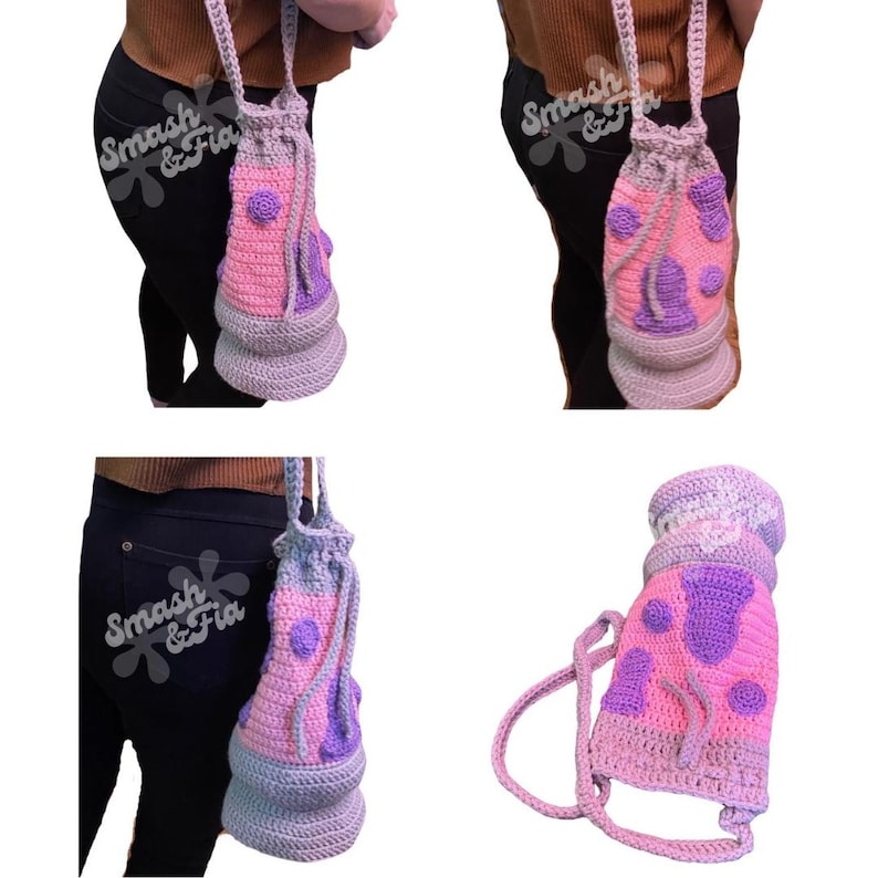May include: A pink and purple crocheted drawstring bag with a white strap. The bag has a polka dot pattern and is shaped like a mushroom.