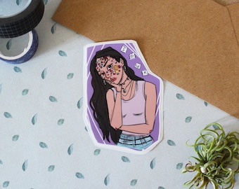 May include: Purple sticker with a drawing of a woman with flowers on her face. She is wearing a pink tank top and has her hair pulled back. The sticker says "Sour" in white letters.