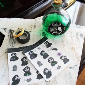 May include: Two sheets of stickers featuring a plague doctor character with a black and white design. The stickers are on a white background and have the text "Plague Bird" on them. A green glass bottle with a label that reads "Night Owl Elixir" is in the background.