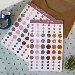 May include: Two sheets of sticker paper with different circle designs. The first sheet has pink, red, and gray circles. The second sheet has pink, gray, red, and gold circles with a marble pattern. Both sheets have the text "Basic Circles" printed on them.