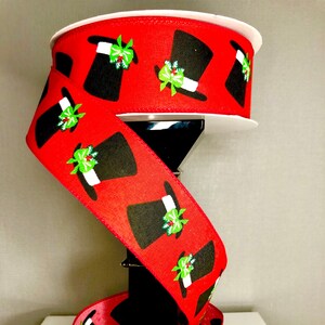 May include: Red ribbon with a black and white pattern of top hats with green holly accents.