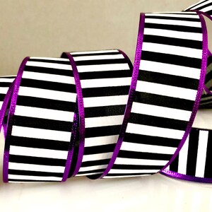 May include: Black and white striped ribbon with a purple metallic edge. The ribbon is 2.5 inches wide.