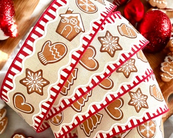 May include: A roll of red and white striped ribbon with a gingerbread cookie design. The ribbon features gingerbread cookies in the shape of a house, mittens, hearts, stars, and trees.