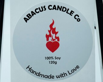May include: A white round sticker with the text "ABACUS CANDLE Co" in black lettering. A red heart with a flame above it is in the center of the sticker. The text "100% Soy 120g Handmade with Love" is below the heart.