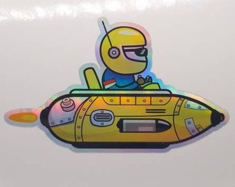 Könnte beinhalten: Ein holografischer Aufkleber mit einer Comicfigur in einem gelben U-Boot mit einem gelben Helm und einer Sonnenbrille.