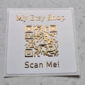 May include: White sticker with gold text and a QR code. The text reads "My Etsy Shop" and "Scan Me!"