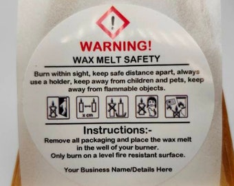 May include: A white circular sticker with a red warning sign and the text "WARNING! WAX MELT SAFETY". The sticker provides safety instructions for using wax melts, including keeping them away from children and pets, using a holder, and burning them on a level fire-resistant surface.