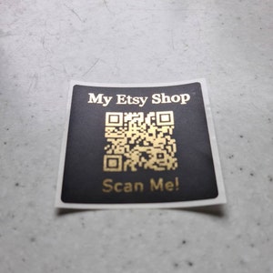 May include: A black and white sticker with a gold QR code and the text "My Etsy Shop" and "Scan Me!"