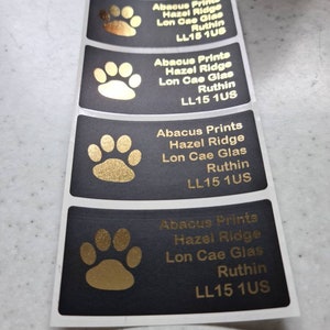 May include: Four black and gold paw print labels with the text "Abacus Prints Hazel Ridge Lon Cae Glas Ruthin LL15 1US" printed on each.