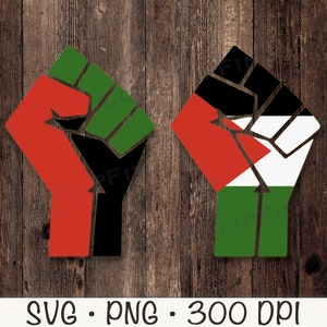 May include: Two raised fists, one with red, black, and green colors and the other with red, white, and green colors. The fists are on a wood background.