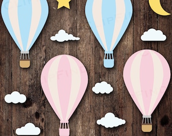 May include: A collection of hot air balloon cutouts in blue and pink with white accents, along with cloud, star, and moon shapes. The image includes the text "SVG • PNG • 300 DPI" at the bottom, all set against a wood grain background.