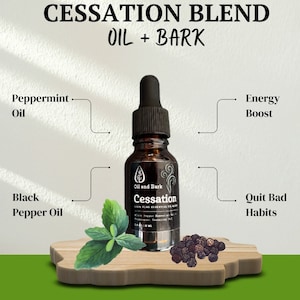 May include: A brown glass bottle with a dropper top, labeled "Oil and Bark Cessation 100% Pure Essential Oil Blend Black Pepper Essential Oil Peppermint Essential Oil 10 ml". The bottle is sitting on a wooden surface with green leaves and black peppercorns.