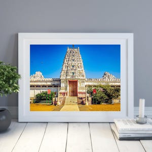 Peut inclure: Un temple blanc avec une porte rouge et un ciel bleu en arrière-plan.