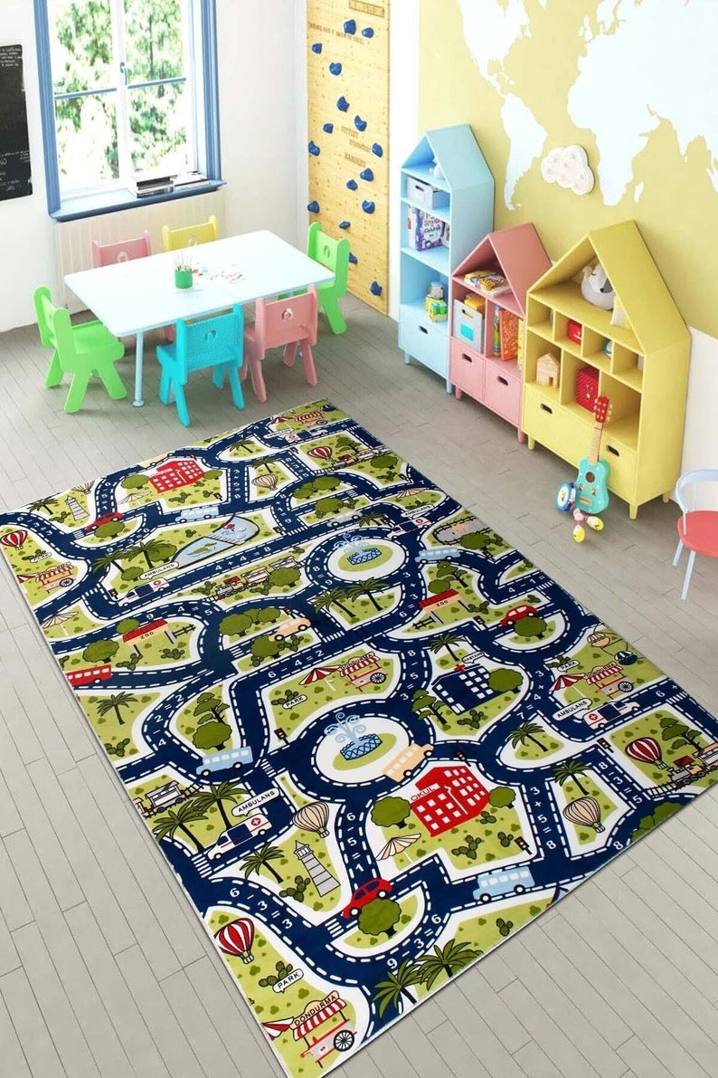May include: A colorful play mat with a road map design featuring cars, buses, hot air balloons, and buildings. The mat is perfect for kids to play with toy cars and learn about numbers and shapes.