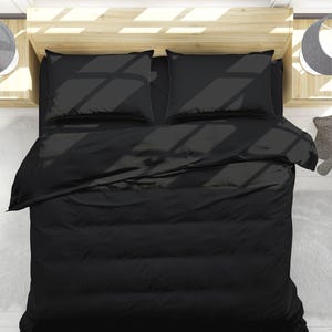May include: Black bedding set with a duvet cover, two pillowcases, and a flat sheet. The bedding is made of a soft, comfortable fabric and is perfect for a modern bedroom.