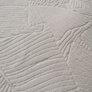 May include: White fluffy rug with a textured pattern of overlapping lines and curves.