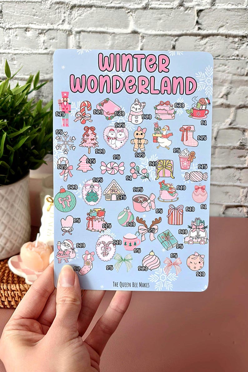 May include: A light blue sticker sheet with the words "Winter Wonderland" in pink. The sheet features various winter-themed illustrations, including a nutcracker, candy canes, and gift boxes. The text "The Queen Bee Makes" is at the bottom.