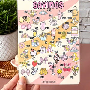 May include: A rectangular card with the text "SUNSHINE AND SAVINGS" and illustrations of summer-themed items like ice cream, sunglasses, and a swimsuit. The card is held by a hand.