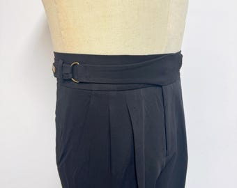 May include: Black high-waisted pants with a wide, black fabric belt with a gold buckle.