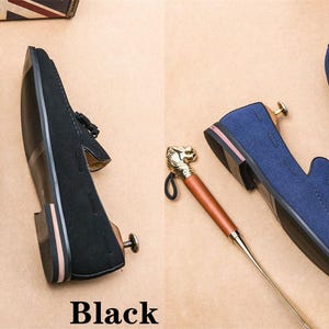 May include: Two pairs of suede tassel loafers. One pair is black and the other is blue.