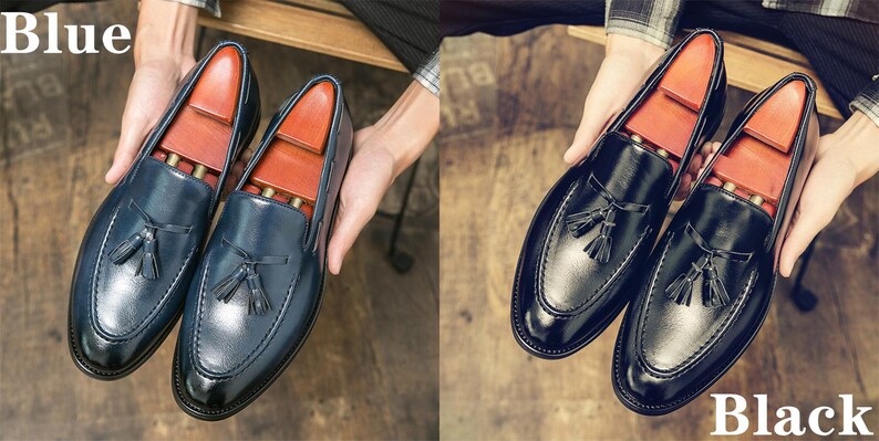 May include: Two pairs of leather tassel loafers, one pair in blue and one pair in black. The loafers have a pointed toe and a tassel detail on the vamp.