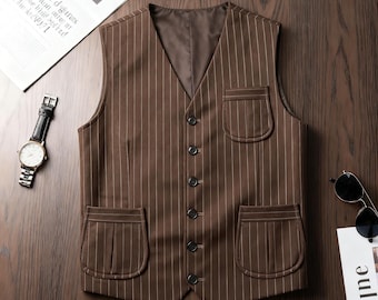 May include: Brown pinstripe vest with four front buttons and two front pockets. The vest has a V-neck and a brown lining. A wristwatch and sunglasses are visible in the background.