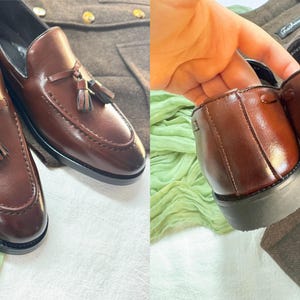 May include: Brown leather tassel loafers with a slip-on design. The shoes have a stitched detail around the toe and a tassel on the top.