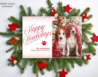 May include: A Christmas card with a red and white plaid blanket over two dogs. The card says "Happy Howlidays" in red cursive text with a paw print below. The text "The Andersons, Blake, Sarah and Duncan" is below the paw print.