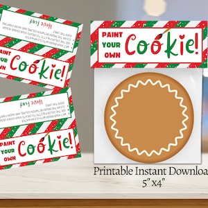 May include: Printable "Paint Your Own Cookie!" activity kit with a blank cookie, paintbrushes, and a red and green striped card with instructions. The card reads "Paint Your Own Cookie!" and "Have Fun!" The kit is 5 inches by 4 inches.