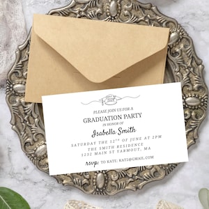 May include: A graduation party invitation with a kraft paper envelope. The invitation is white with black text, including the graduate's name, date, time, and location. The invitation is on a decorative silver tray.