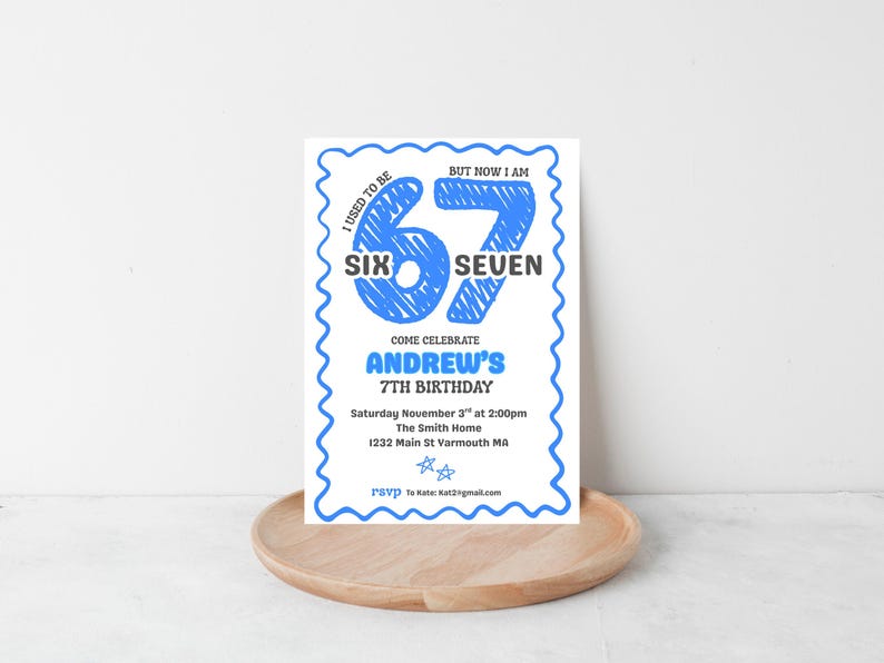 May include: A white invitation with a blue scalloped border. The text reads "I used to be SIX, but now I am SEVEN." It announces Andrew's 7th birthday, with date, time, and location details. The invitation is on a wooden tray.