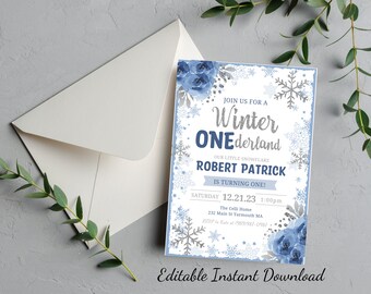 May include: A blue and silver winter wonderland themed first birthday party invitation with snowflakes and floral accents. The invitation reads "Join us for a Winter One-derland. Our little snowflake Robert Patrick is turning one! Saturday 12.21.23 1:00pm The Celli Home 232 Main St Yarmouth MA RSVP to Kate at 989/982-0987".