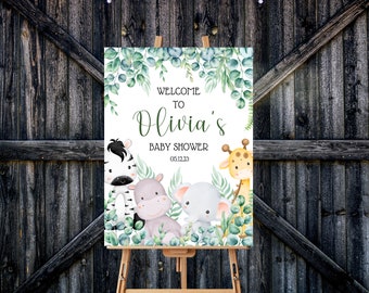 May include: Welcome to Olivia's Baby Shower sign with a green leafy border and watercolor illustrations of a zebra, hippopotamus, elephant, and giraffe. The date 06.12.23 is printed below the text.
