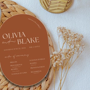 May include: A terracotta-coloured oval wedding ceremony order of service card with the names Olivia and Blake, the date Saturday June 22, 2024, and the location The Castle. The card lists the order of ceremony, including the processional, reading, exchange of vows, exchange of rings, reading, pronouncement, and recessional.