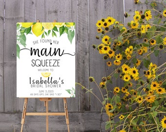 May include: A white sign with a lemon and leaf design. The text on the sign reads "She found her main squeeze. Welcome to Isabella's Bridal Shower. June 5, 2023. 48 days until she said "I do."