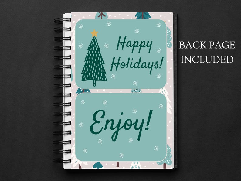 May include: A spiral bound notebook with a white background and a green Christmas tree design. The front cover has two stickers with the text "Happy Holidays!" and "Enjoy!"