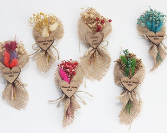 May include: Six small bouquets of dried flowers tied with burlap ribbon and attached to a wooden heart-shaped tag. Each tag has the text "Name & Name Date" engraved on it.