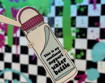 May include: A white water bottle with a pink lid and a blue and white floral design. The bottle has the text "This is my emotional support water bottle" printed on it.