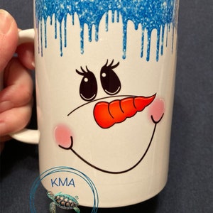 Snowman face “chillin” hot cocoa/ coffee mug with blue glitter dripping from top 15oz mug