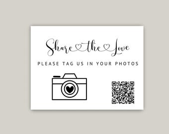 May include: White card with black text that says "Share the Love" and "Please tag us in your photos". There is a black and white illustration of a camera with a heart in the viewfinder and a black and white QR code.