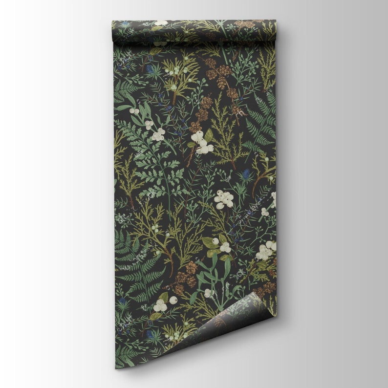 May include: A roll of wallpaper featuring a dark background with a botanical pattern. The design includes various green ferns, white berries, and brown pinecones. The wallpaper is unrolled, revealing the pattern.