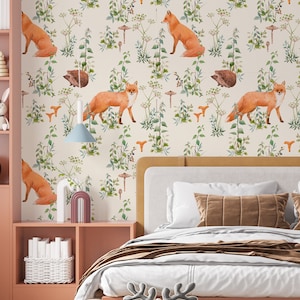 May include: Wallpaper featuring a repeating pattern of orange foxes, brown hedgehogs, and orange mushrooms amidst green foliage on a cream background. The scene is set in a bedroom with a bed, shelves, and decorative items.